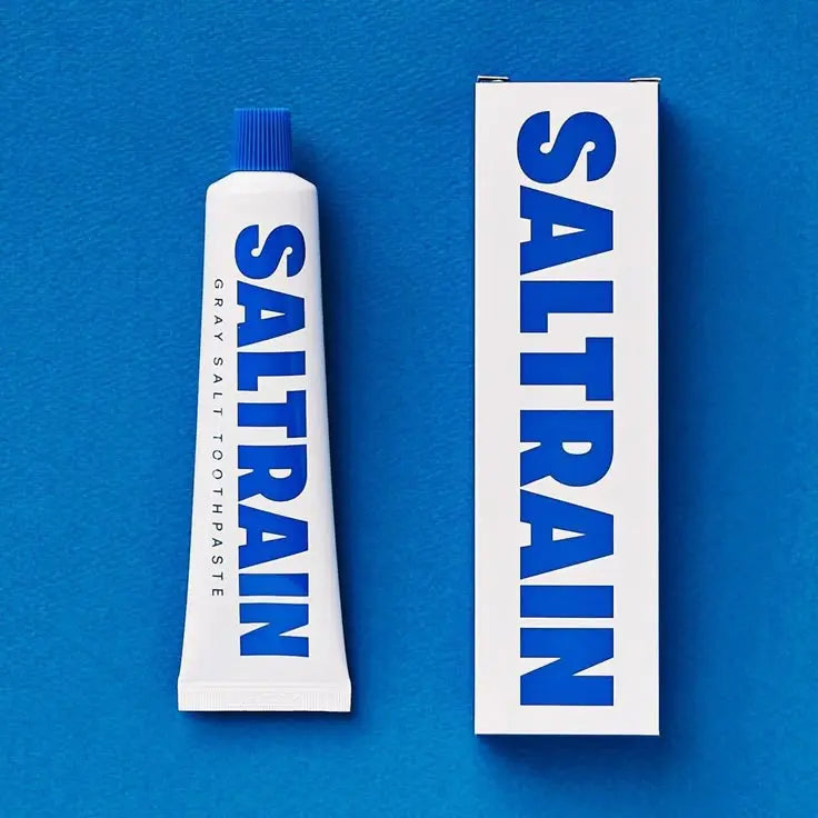 SALTRAIN toothpaste tube and packaging on a blue background