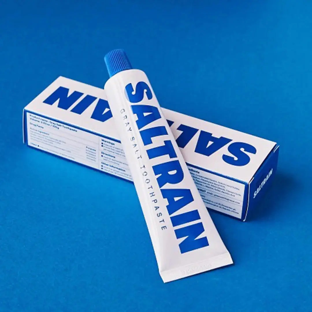 Saltrain toothpaste tube and box on a blue background