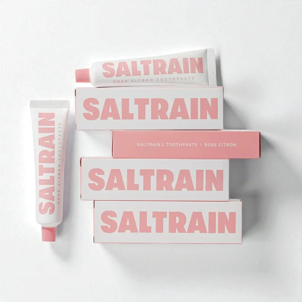 Collection of Saltrain toothpaste and boxes on a white background