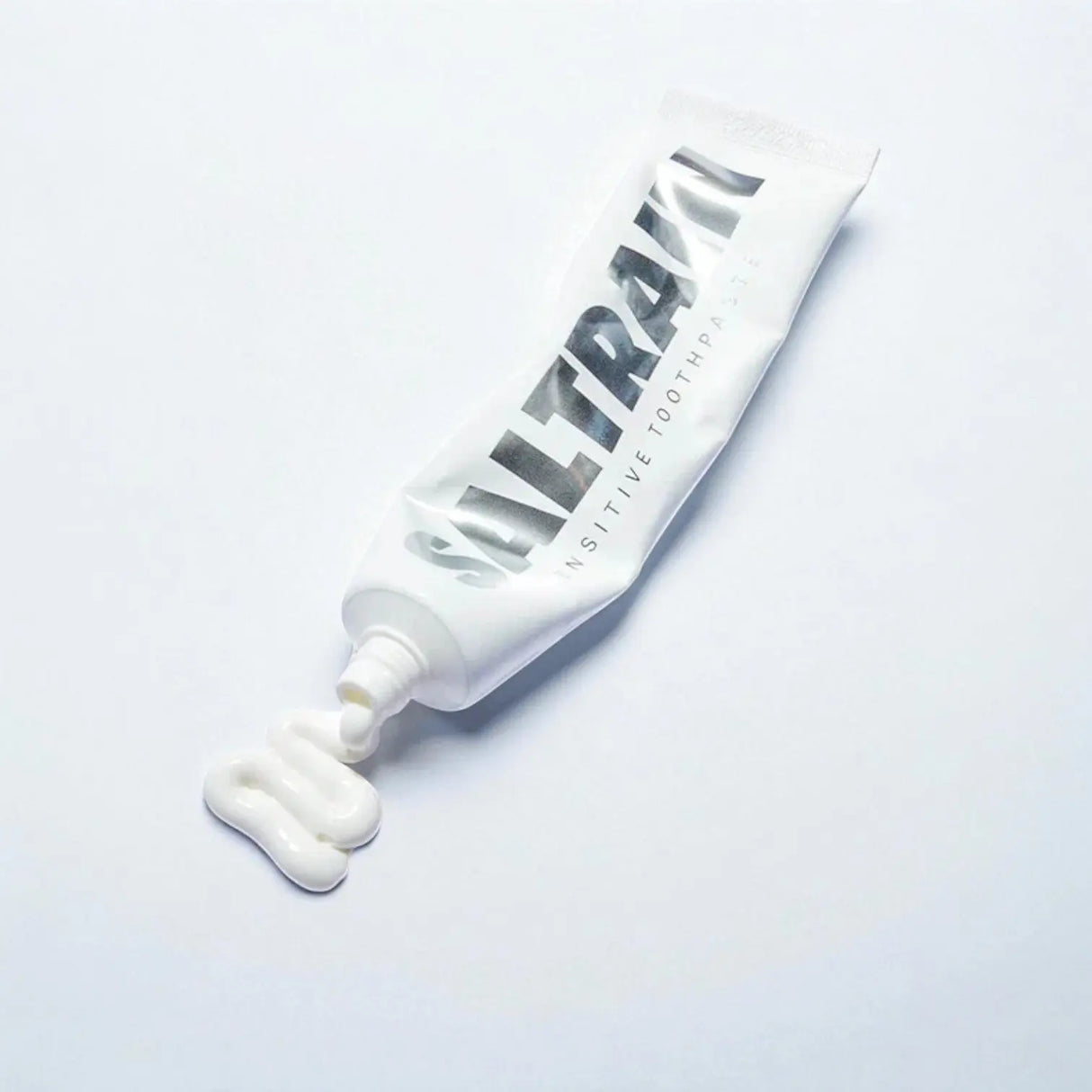Saltrain branded toothpaste tube on a light gray background