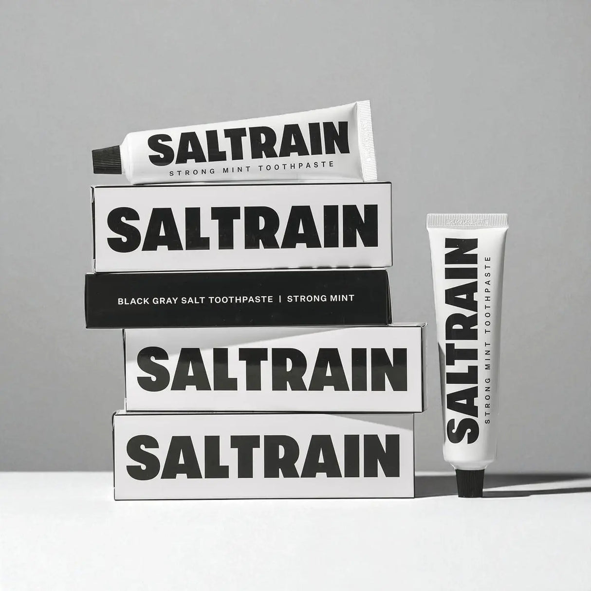 Saltrain toothpaste packaging on a gray background