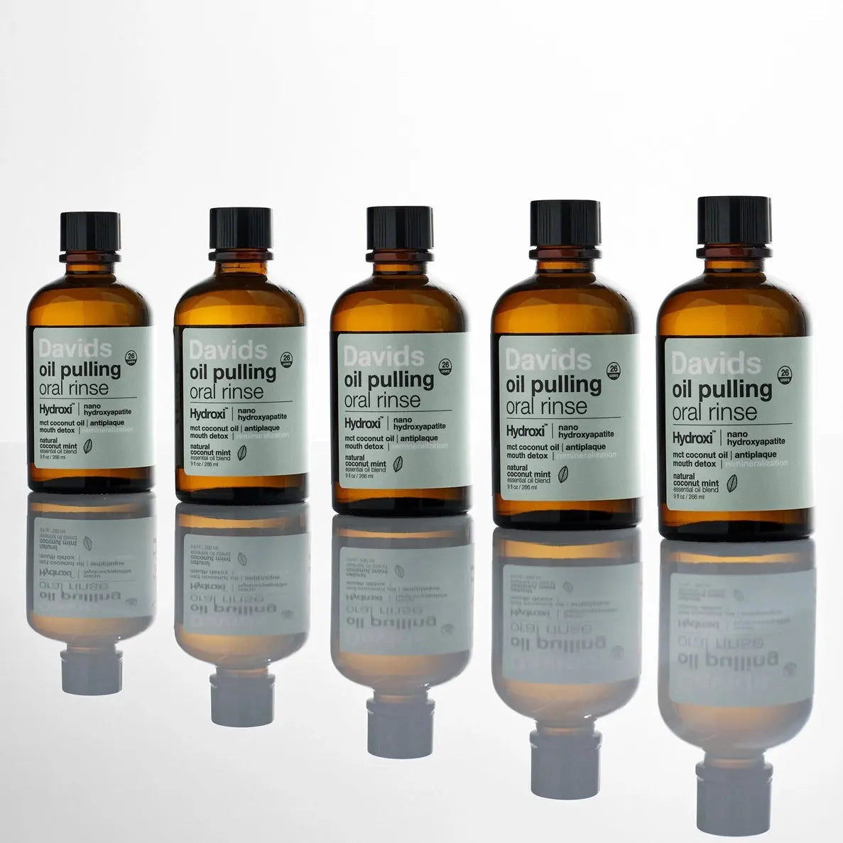 Six bottles of Davids oil pulling oral rinse on a white background