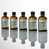 Six bottles of Davids oil pulling oral rinse on a white background