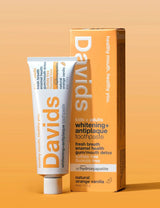 David's toothpaste tube and packaging on an orange background