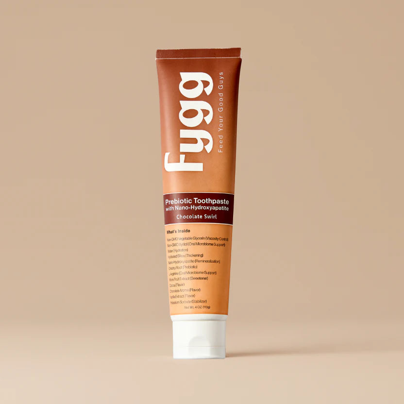 Fygg prebiotic toothpaste tube on a beige background