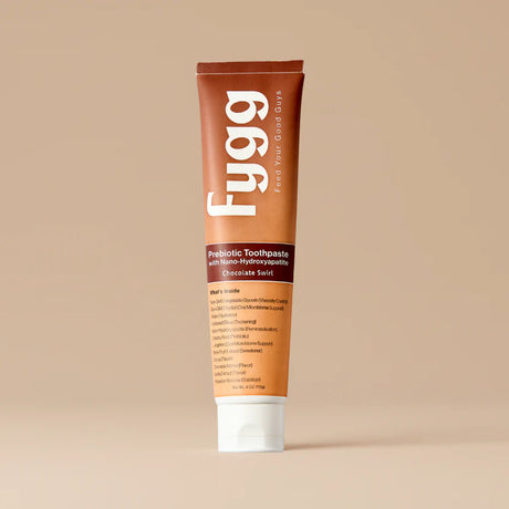 Fygg prebiotic toothpaste tube on a beige background