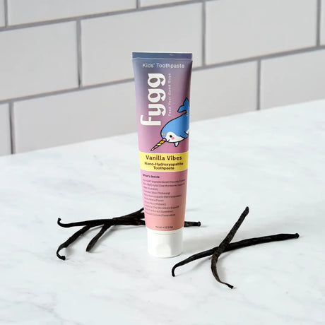 Fygg kids toothpaste tube with vanilla beans on a white surface