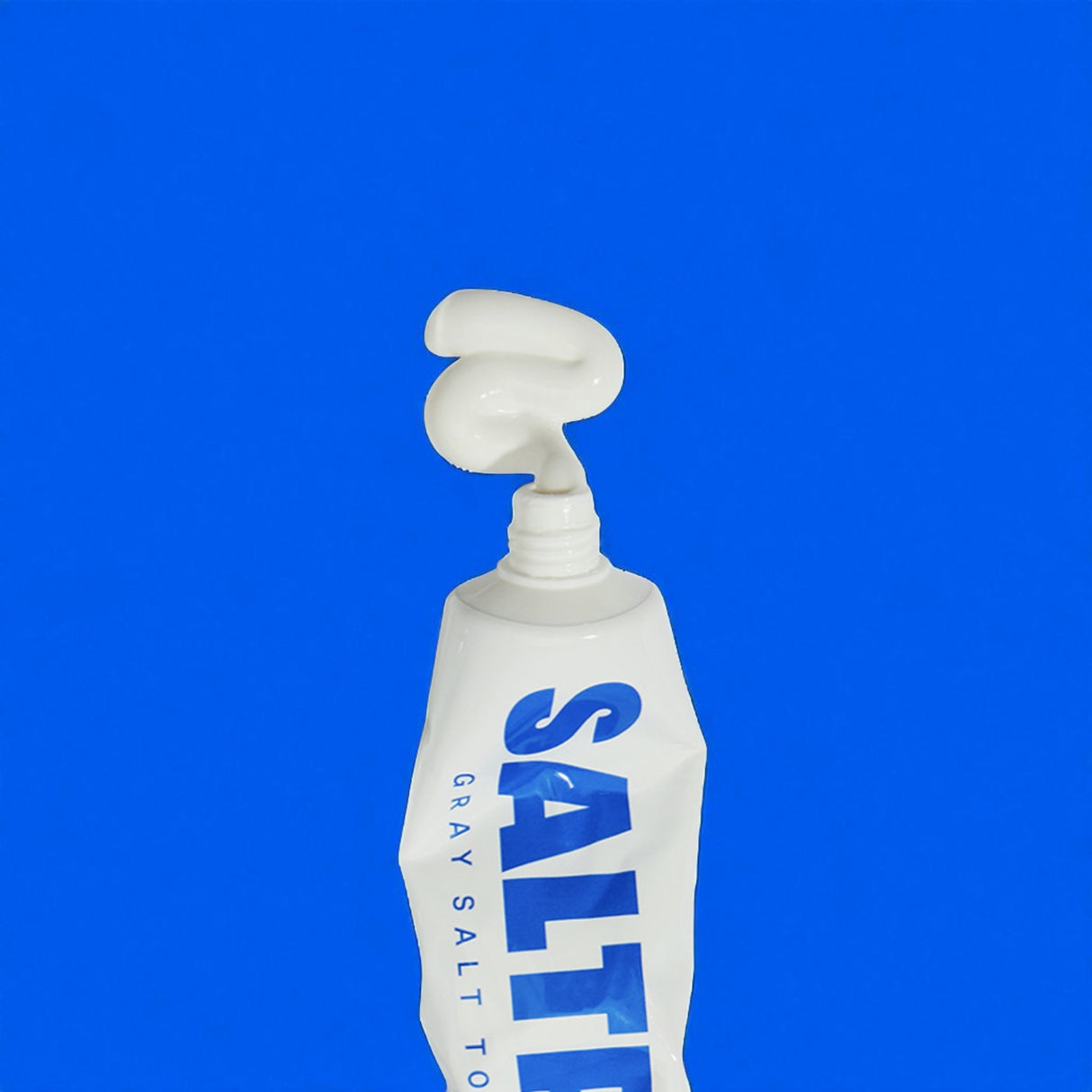 Saltrain toothpaste tube with blue text on a blue background