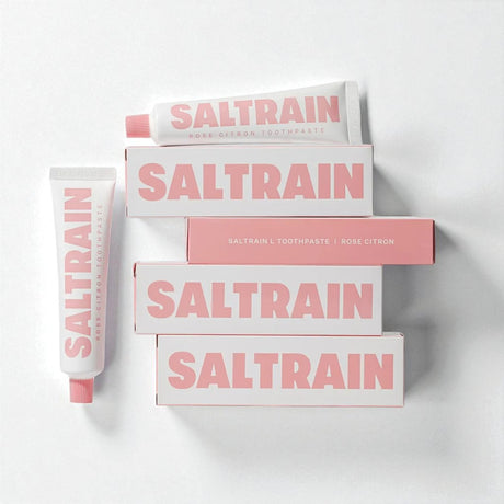 Collection of Saltrain toothpaste and boxes on a white background