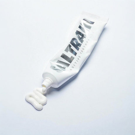 Saltrain branded toothpaste tube on a light gray background