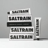 Saltrain toothpaste packaging on a gray background